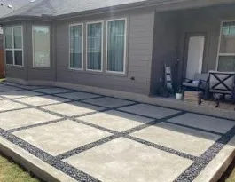 Concrete pad patio running along the back of a house, cropped from a flyer